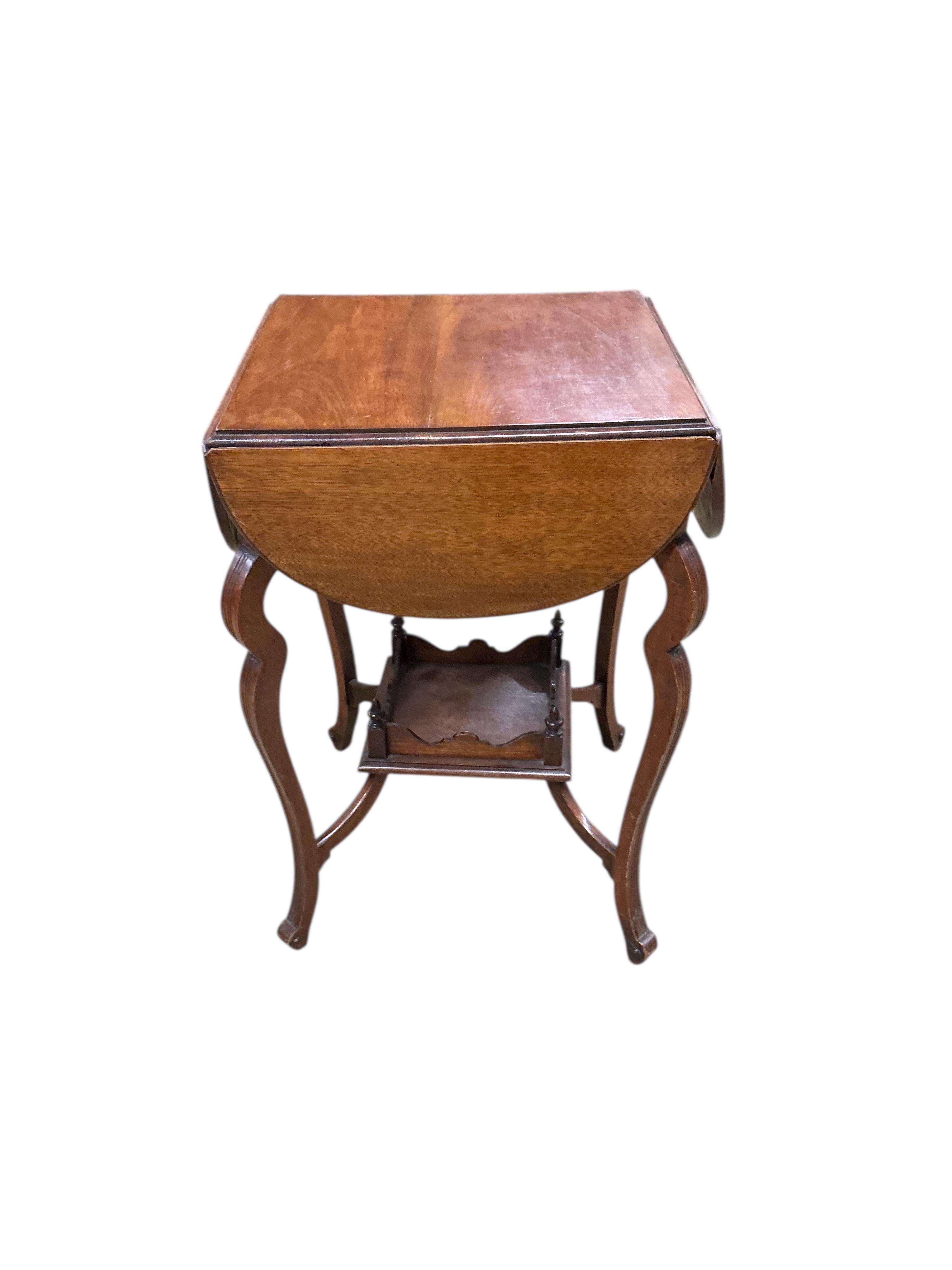 A late Victorian walnut drop flap centre table, width 45cm, height 68cm